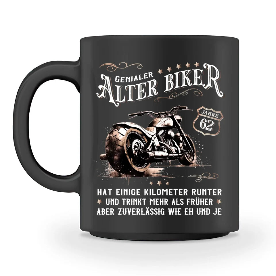 Eine personalisierbare Biker Geburtstags-Tasse für Motorradfahrer, von Wingbikers, mit dem beidseitigen Aufdruck, Genialer Alter Biker - Einige Kilometer runter, trinkt mehr - aber zuverlässig wie eh und je, in schwarz.