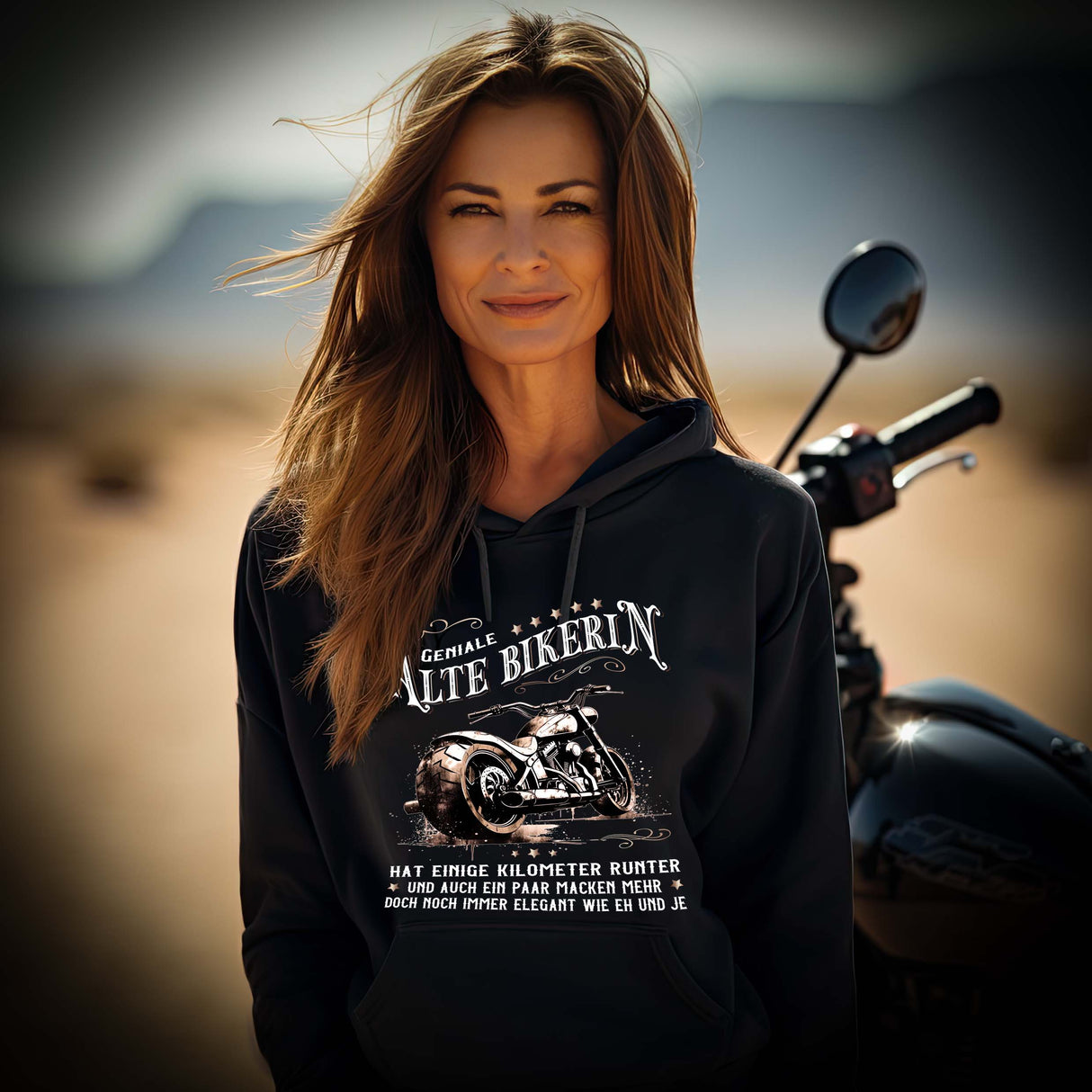 Eine Bikerin mit einem Hoodie für Motorradfahrerinnen von Wingbikers mit dem Aufdruck, Alte Bikerin - Einige Kilometer Runter - Doch elegant wie eh und je - gerader Schnitt, in schwarz.