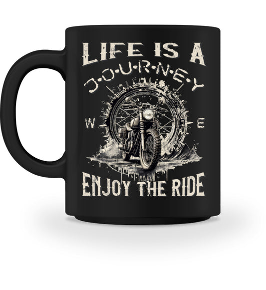 Eine Tasse für Motorradfahrer von Wingbikers, mit dem beidseitigen Aufdruck, Life Is A Journey - Enjoy The Ride, in schwarz.