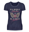 Ein T-Shirt für Motorradfahrerinnen von Wingbikers mit dem Aufdruck, In A World Full Of Princesses - Be A Biker Girl, in navy blau.