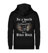 Ein Bikerin Zip-Hoodie für Motorradfahrerinnen von Wingbikers mit dem Aufdruck, In a world full of Princesses, be a Biker Bitch - in schwarz.