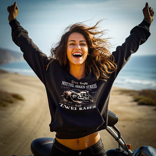 Ein Damen Hoodie von Wingbikers für Motorradfahrerinnen mit dem Aufdruck, Das beste Mittel gegen Stress hat 2 Räder, in schwarz.